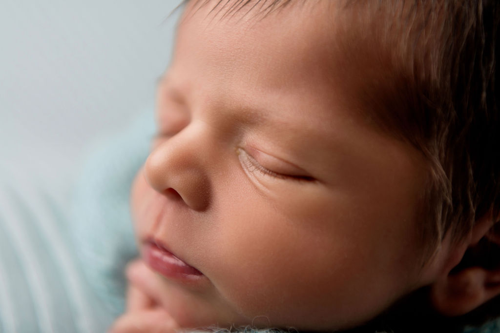 Details of a newborn baby's face while it sleeps